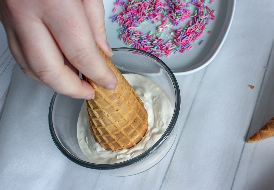 Dip the cones into the melted chocolate and roll in colored sprinkles.